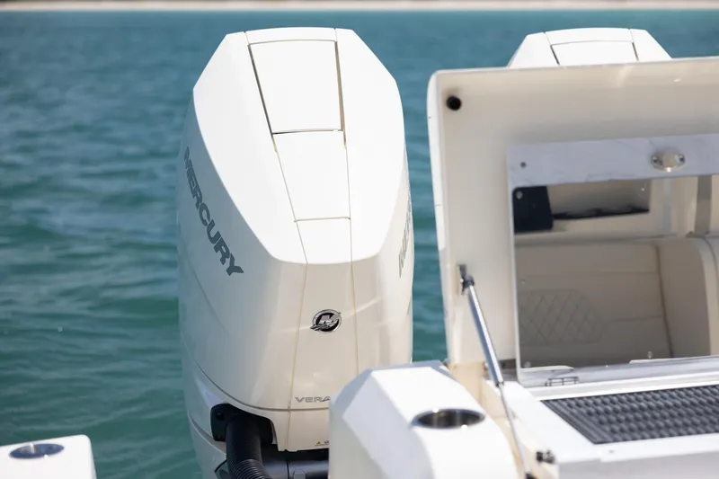  Yacht Photos Pics 2024 Scout 377 LXF boat with Mercury outboard engine on calm water.