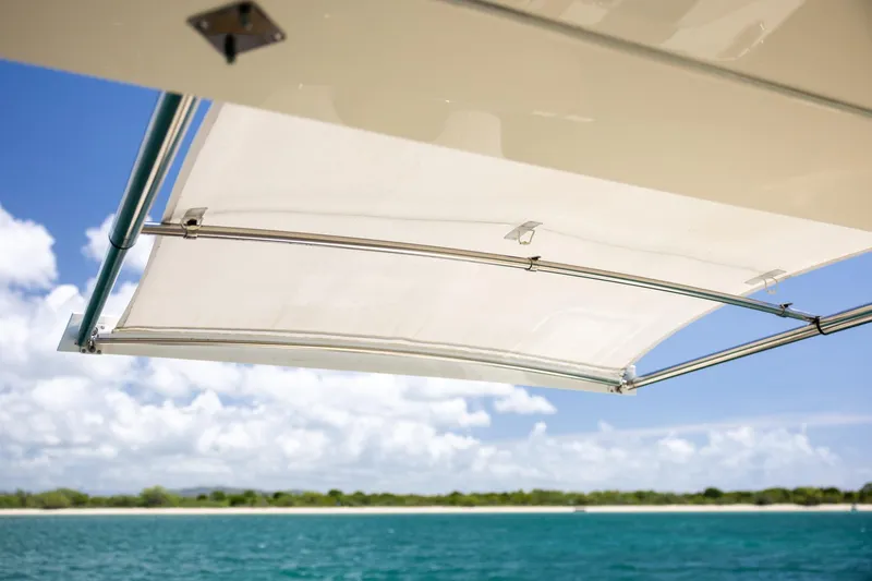  Yacht Photos Pics 2024 Scout 377 LXF boat canopy with ocean and sky background.