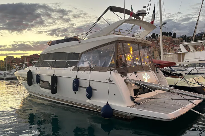  Yacht Photos Pics 2018 Prestige 560 yacht docked at sunset, featuring elegant design and modern amenities.