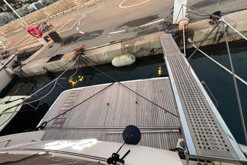  Yacht Photos Pics Docked Prestige 560 yacht, 2018 model, with wooden deck and gangway at marina.