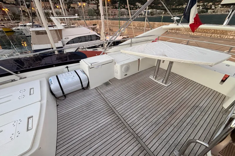  Yacht Photos Pics 2018 Prestige 560 yacht deck with table, storage, and marina view.