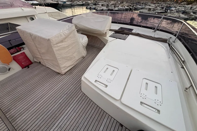  Yacht Photos Pics 2018 Prestige 560 yacht deck with covered seating and storage compartments.