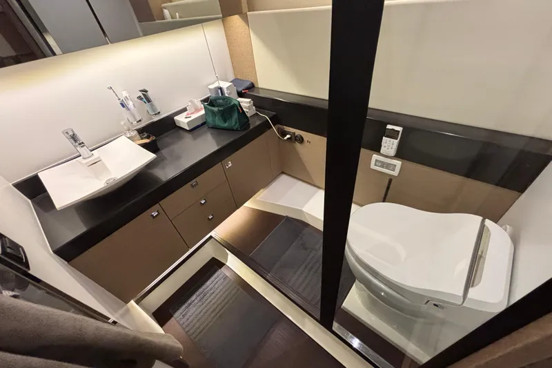  Yacht Photos Pics Luxurious bathroom in 2018 Prestige 560 yacht with modern fixtures and sleek design.