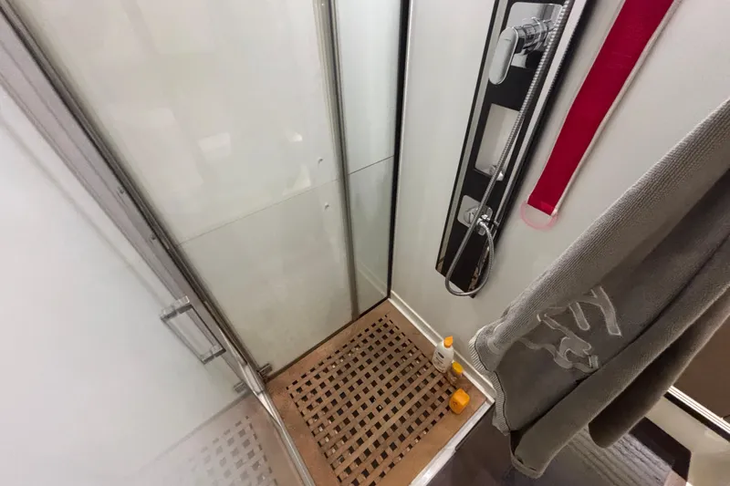  Yacht Photos Pics Shower area in 2018 Prestige 560 yacht with wooden floor and modern fixtures.