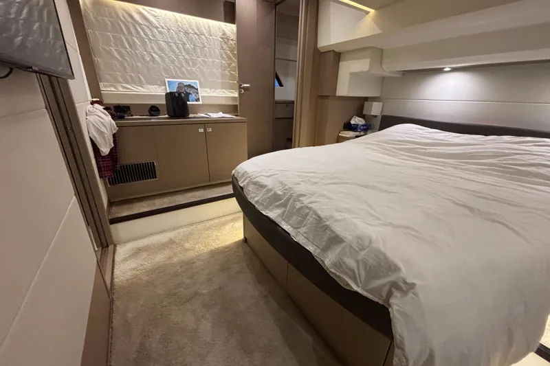  Yacht Photos Pics Luxurious bedroom interior of 2018 Prestige 560 yacht with modern design and cozy ambiance.
