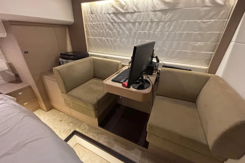  Yacht Photos Pics Luxurious interior of 2018 Prestige 560 yacht with cozy seating and computer setup.