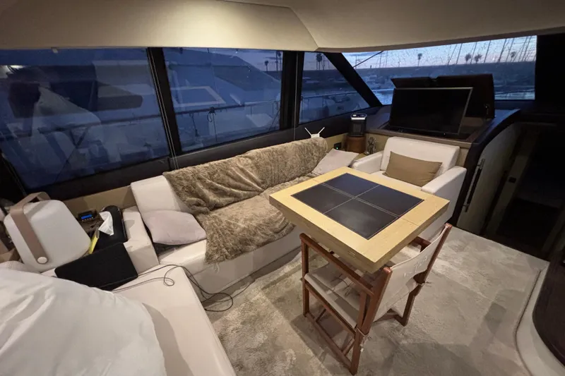  Yacht Photos Pics Luxurious interior of a 2018 Prestige 560 yacht with cozy seating and elegant decor.