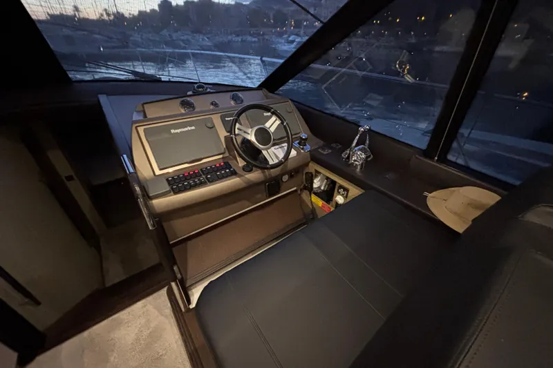  Yacht Photos Pics Helm of 2018 Prestige 560 yacht with steering wheel and navigation equipment.