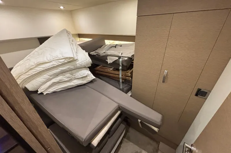  Yacht Photos Pics Interior cabin of 2018 Prestige 560 yacht with bedding and storage.