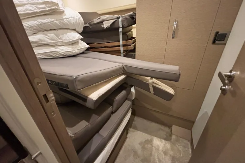  Yacht Photos Pics Storage area with stacked cushions and bedding in a 2018 Prestige 560 yacht.