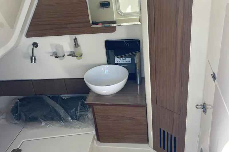  Yacht Photos Pics 2020 Chris-Craft Catalina 30 interior with modern sink and wooden cabinetry.