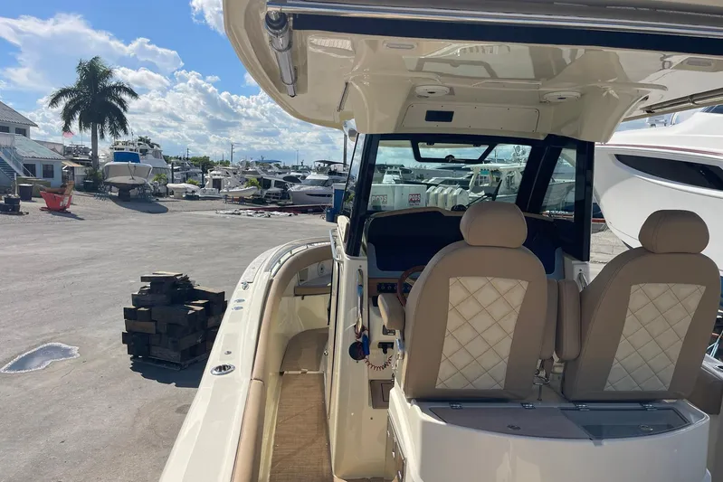  Yacht Photos Pics 2020 Chris-Craft Catalina 30 boat interior with beige seats at a marina.