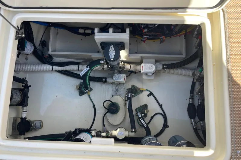  Yacht Photos Pics Engine compartment of 2020 Chris-Craft Catalina 30, showcasing hoses and mechanical components.