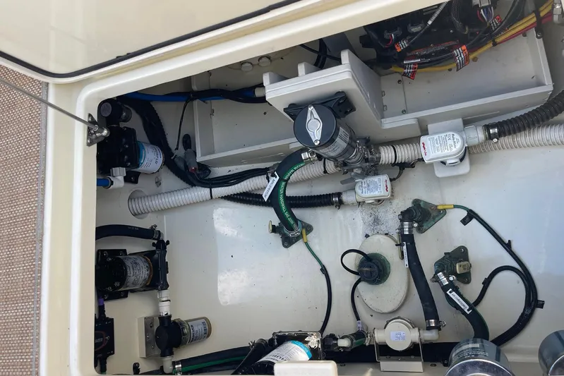  Yacht Photos Pics Engine compartment of a 2020 Chris-Craft Catalina 30, showcasing various mechanical components and wiring.