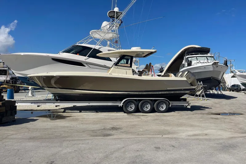  Yacht Photos Pics 2020 Chris-Craft Catalina 30 boat on trailer in marina, clear blue sky background.