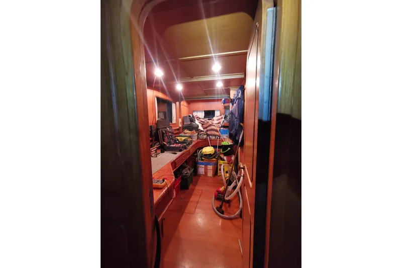  Yacht Photos Pics Interior of 2001 Ortona Navi 115 yacht, featuring a cluttered workspace with tools and equipment.