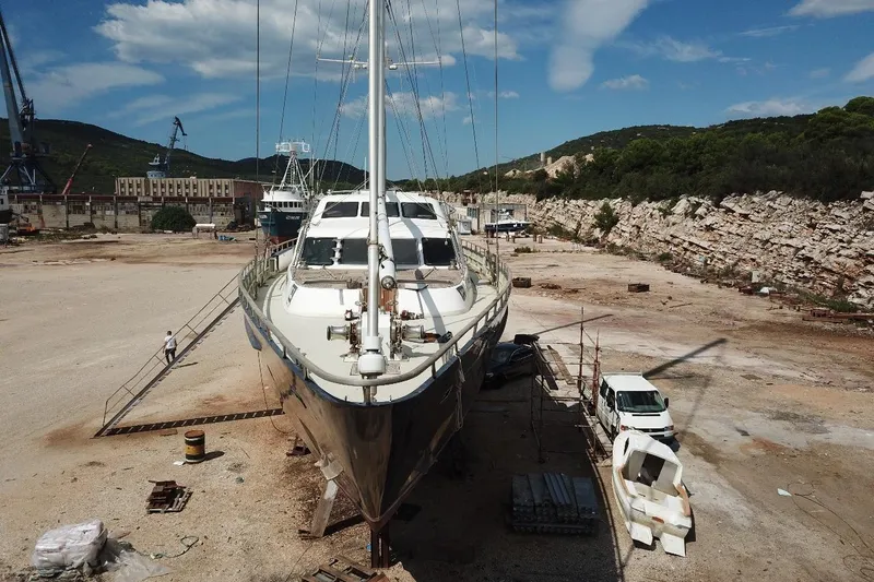  Yacht Photos Pics Ortona Navi 115 yacht from 2001 in dry dock, surrounded by equipment and vehicles.