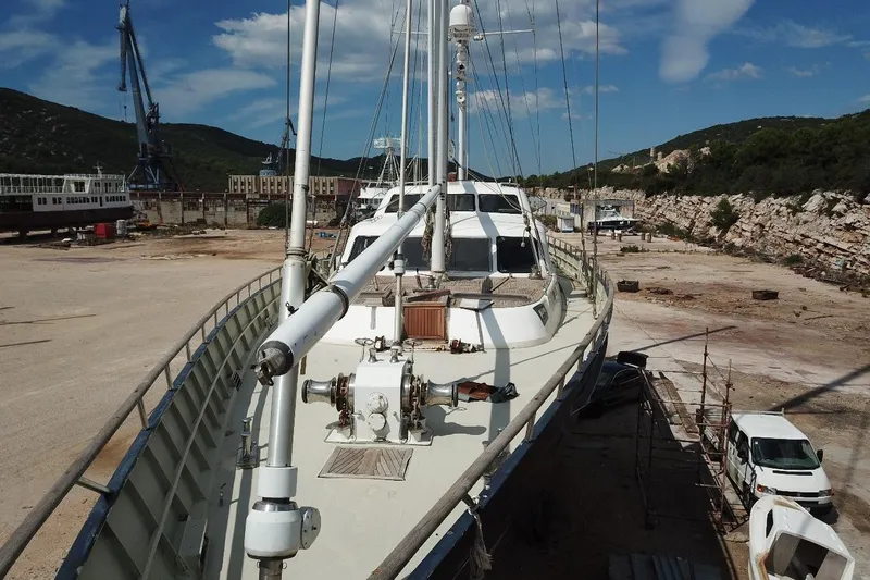  Yacht Photos Pics Ortona Navi 115 yacht from 2001 docked in a shipyard under a clear blue sky.