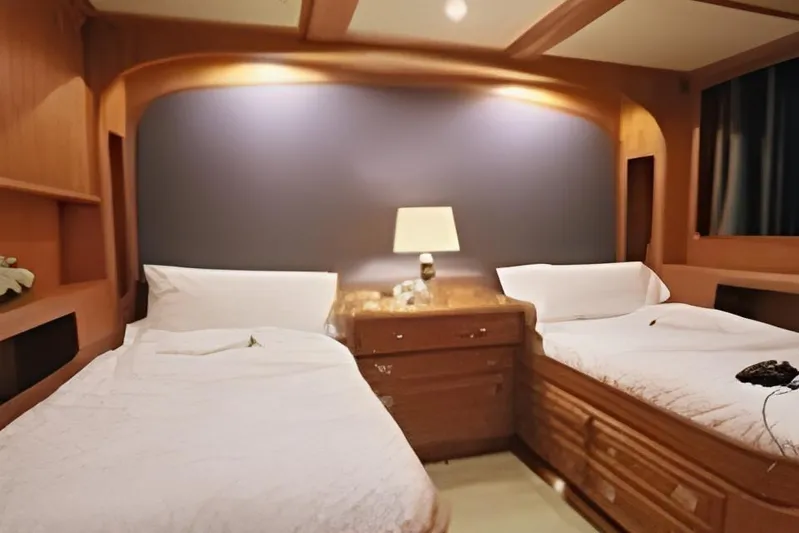  Yacht Photos Pics Luxurious twin cabin interior on Ortona Navi 115 yacht, 2001 model, featuring elegant wood finishes.