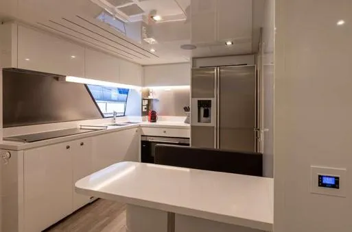  Yacht Photos Pics Modern kitchen interior on 2016 Custom Line Navetta 28 yacht, featuring sleek design and stainless steel appliances.