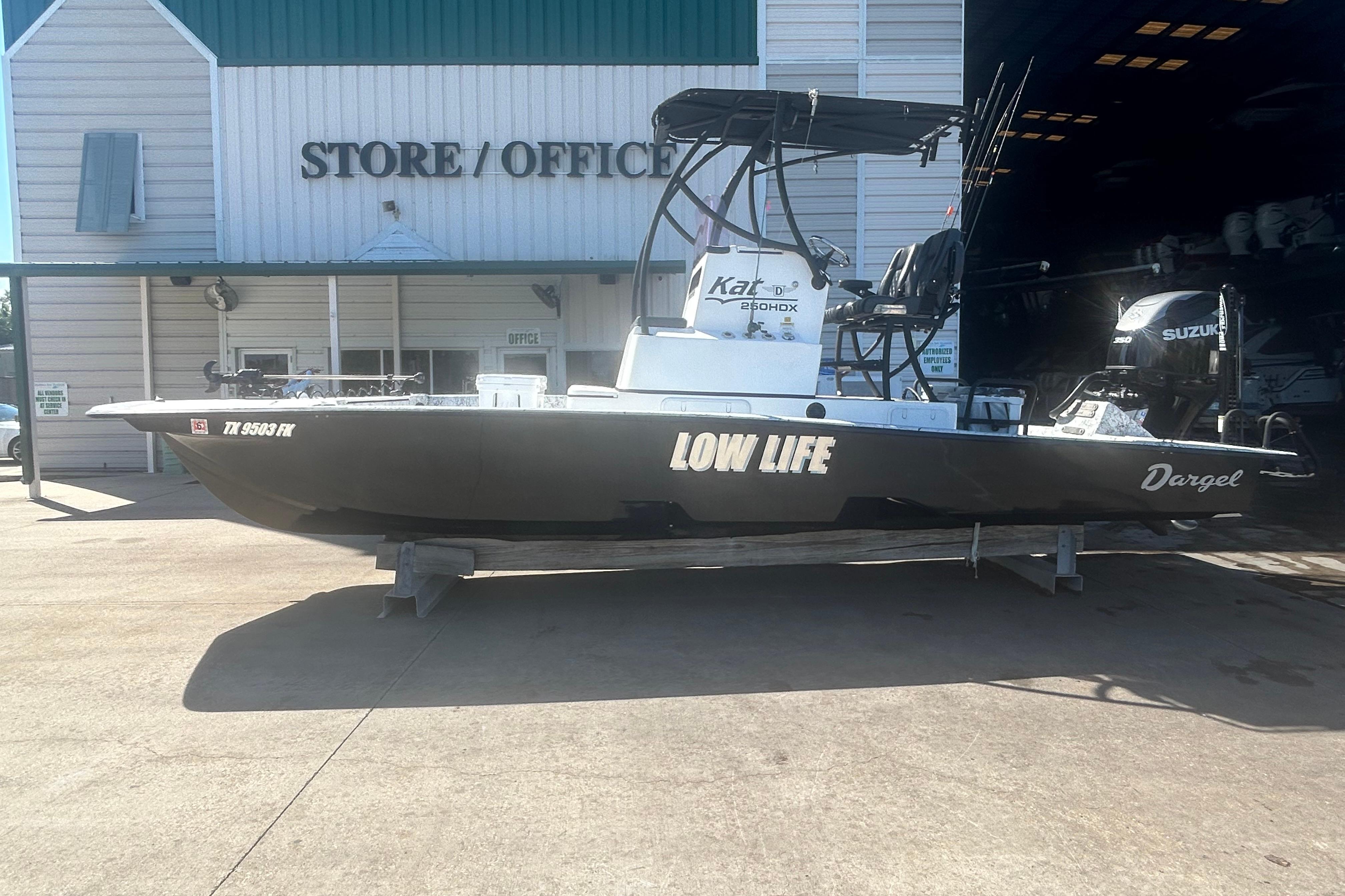 2020 Dargel Kat 250 HDX boat named "Low Life" outside store/office.