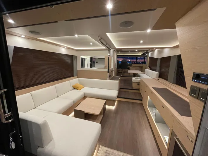  Yacht Photos Pics Luxurious interior of 2024 Beneteau Grand Trawler 62 with modern furnishings and ambient lighting.
