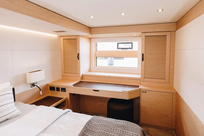  Yacht Photos Pics Luxurious cabin interior of 2024 Beneteau Grand Trawler 62 with modern wood finish.
