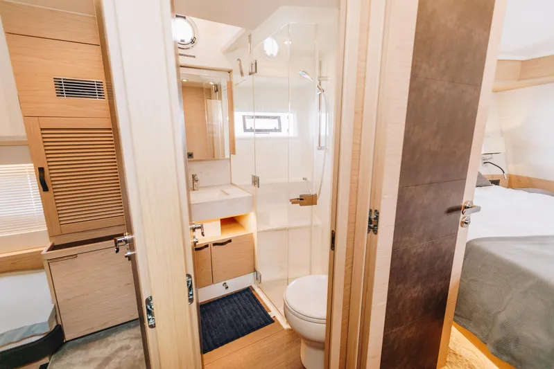  Yacht Photos Pics Luxurious bathroom interior of 2024 Beneteau Grand Trawler 62 yacht.