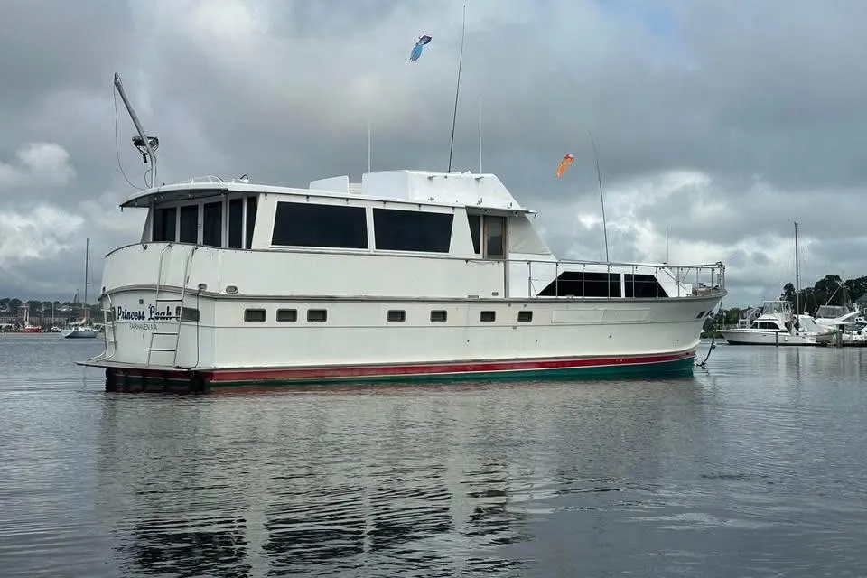 1975 Pacemaker 62 Motor Yacht on calm water, overcast sky background.