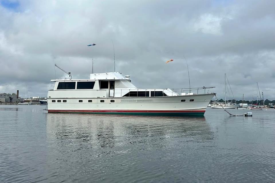 1975 Pacemaker 62 Motor Yacht on calm water under cloudy sky.