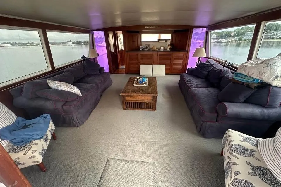 Interior of 1975 Pacemaker 62 Motor Yacht with cozy seating and panoramic windows.