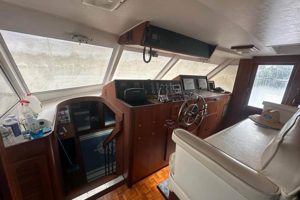 Interior of 1975 Pacemaker 62 Motor Yacht with helm, steering wheel, and navigation equipment.