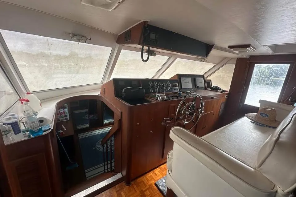 Interior of 1975 Pacemaker 62 Motor Yacht with helm, steering wheel, and navigation equipment.