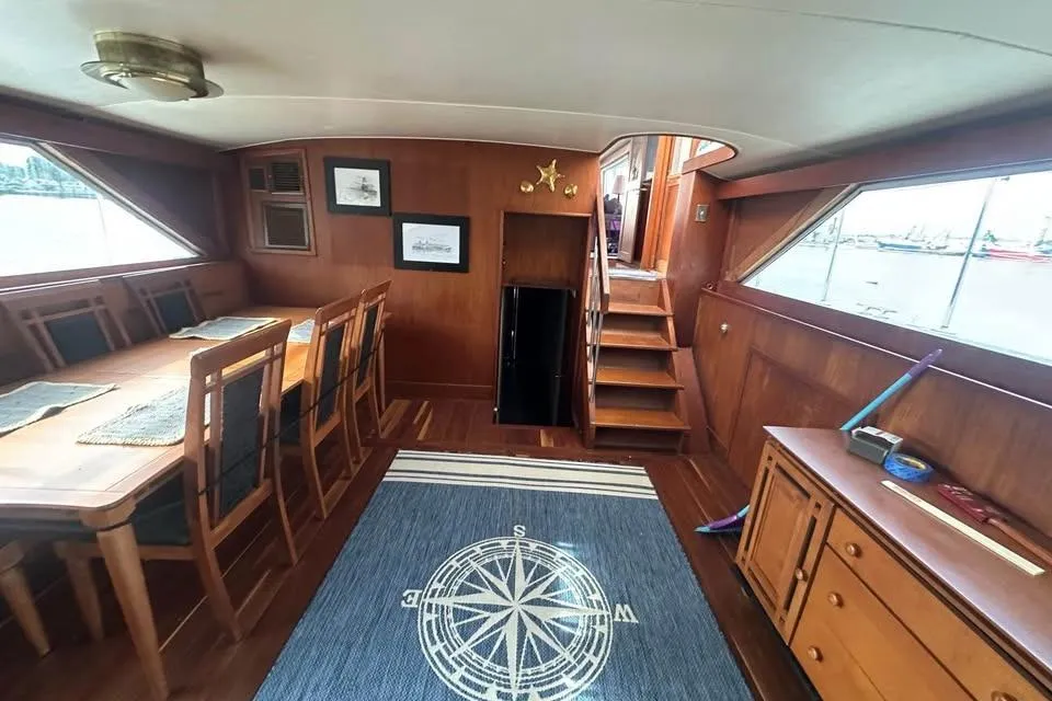 Interior of 1975 Pacemaker 62 Motor Yacht with dining area and nautical decor.