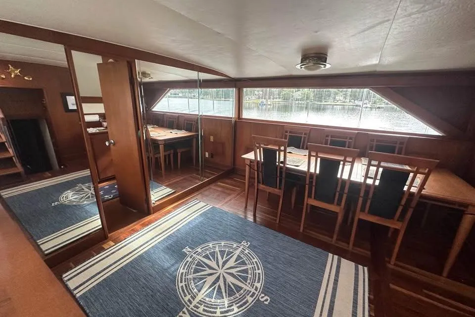 Interior of 1975 Pacemaker 62 Motor Yacht with dining area and nautical-themed decor.