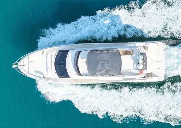  Yacht Photos Pics Aerial view of 2019 Ferretti Yachts 670 cruising on turquoise water.
