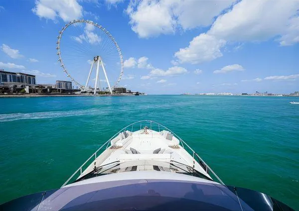 Yacht Photos Pics 2019 Ferretti Yachts 670 cruising near a Ferris wheel on a sunny day.