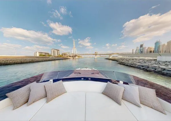 Yacht Photos Pics Luxurious 2019 Ferretti Yachts 670 cruising with cityscape and Ferris wheel in the background.