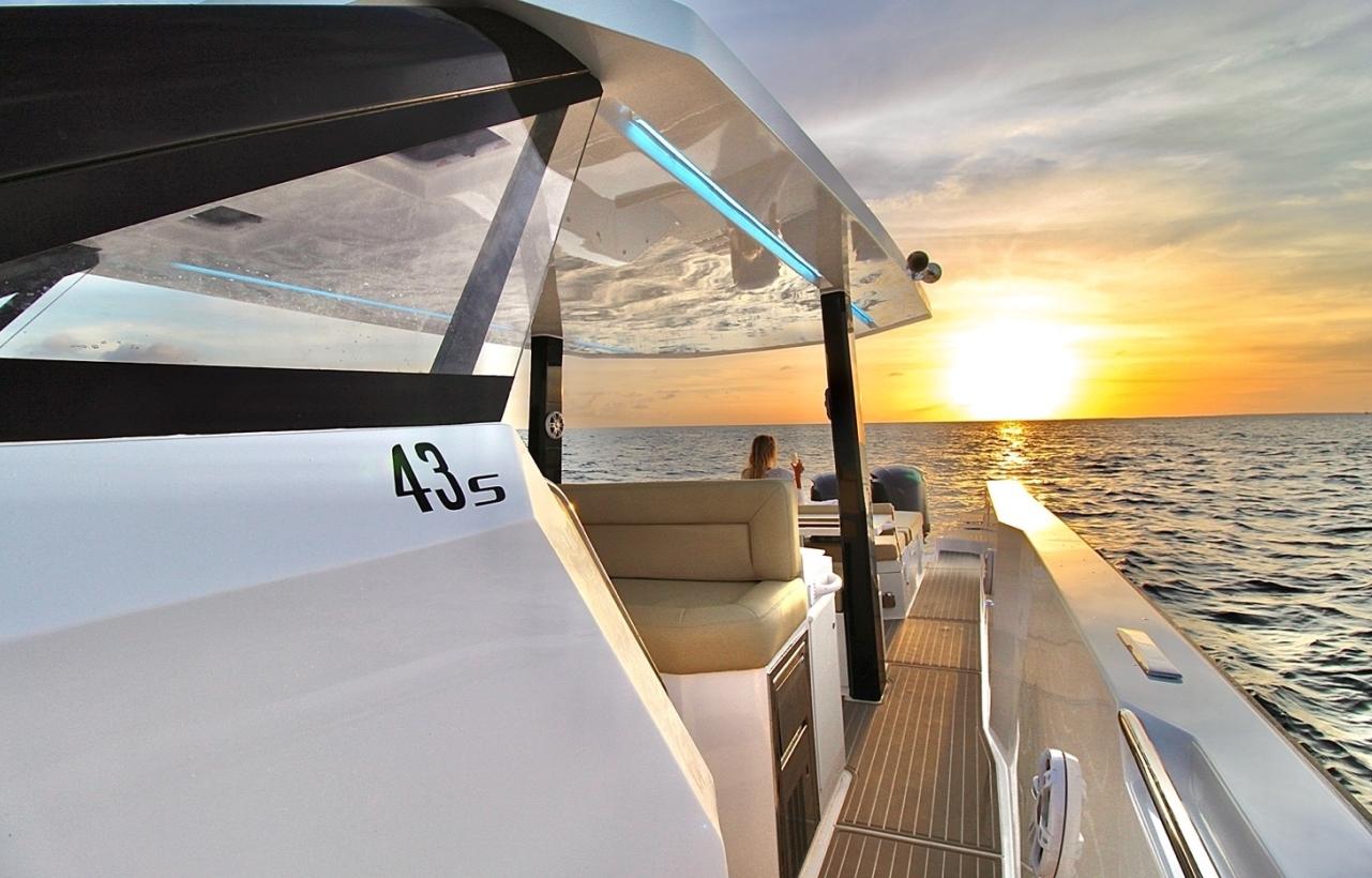 2025 Impulse 43 S yacht cruising at sunset on the ocean.