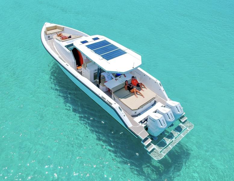2025 Impulse 43 S yacht with solar panels cruising on clear turquoise water.