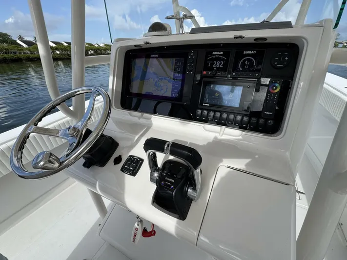 High Time Yacht Photos Pics Control panel of a 2004 Jupiter 31 boat with navigation and steering equipment.