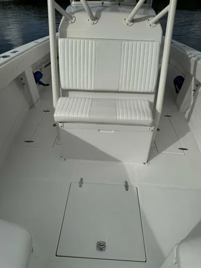 High Time Yacht Photos Pics 2004 Jupiter 31 boat interior with white seating and storage compartments.