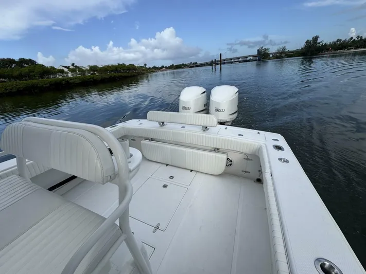 High Time Yacht Photos Pics 2004 Jupiter 31 boat with twin engines on calm water, featuring white seating and spacious deck.