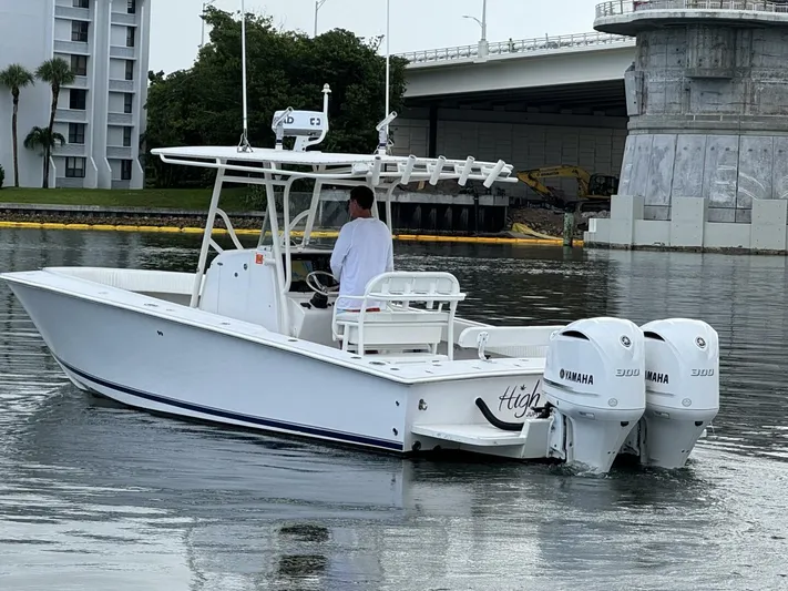 High Time Yacht Photos Pics A 2004 Jupiter 31 boat with twin Yamaha engines on a calm waterway.