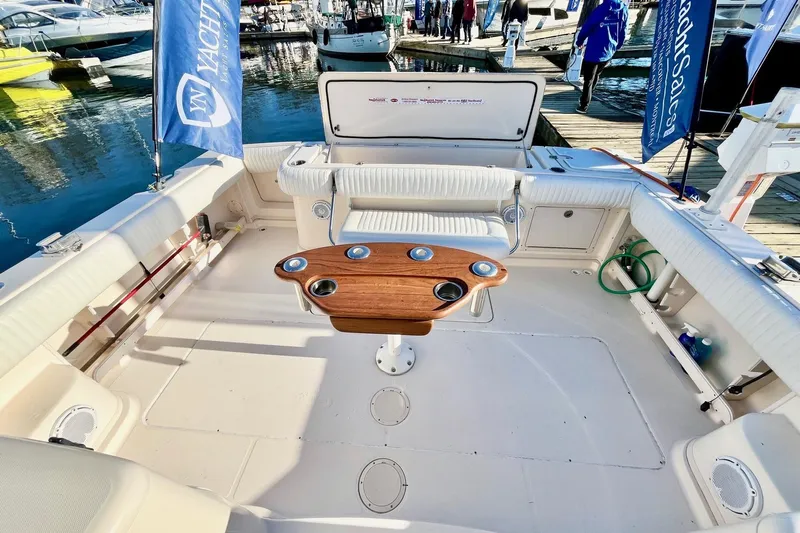  Yacht Photos Pics 2005 Grady-White Express 360 boat interior with seating and wooden table at marina.