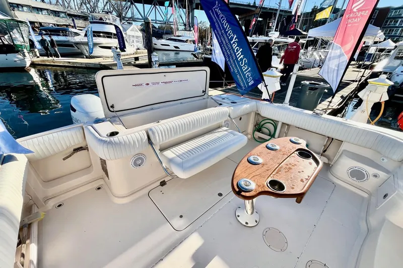  Yacht Photos Pics 2005 Grady-White Express 360 boat interior with seating and table at a marina.