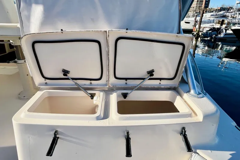  Yacht Photos Pics Open storage compartments on a 2005 Grady-White Express 360 boat at a marina.