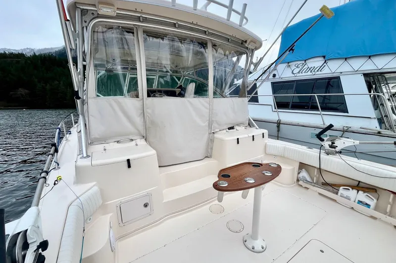  Yacht Photos Pics 2005 Grady-White Express 360 boat interior with seating and table, docked by water.
