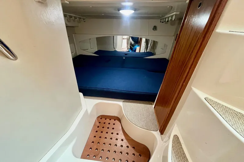  Yacht Photos Pics 2005 Grady-White Express 360 cabin interior with blue bedding and wooden accents.