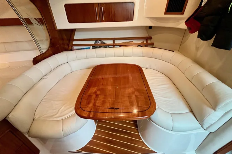  Yacht Photos Pics Luxurious interior of 2005 Grady-White Express 360 with elegant wood table and plush seating.